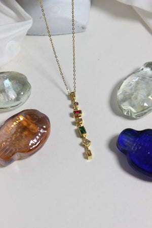 Chromatique Necklace on a white surface with colorful stones