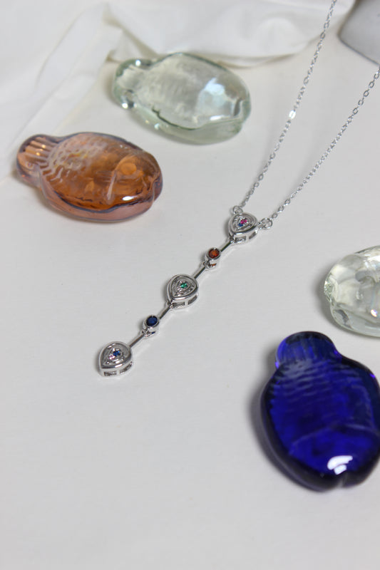 Celeste Pour Necklace on a white surface