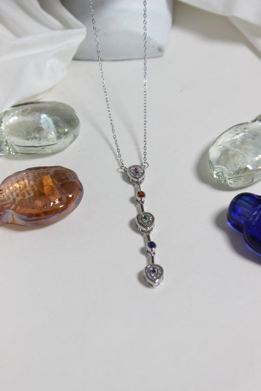 Celeste Pour Necklace with colorful pendant on a white surface