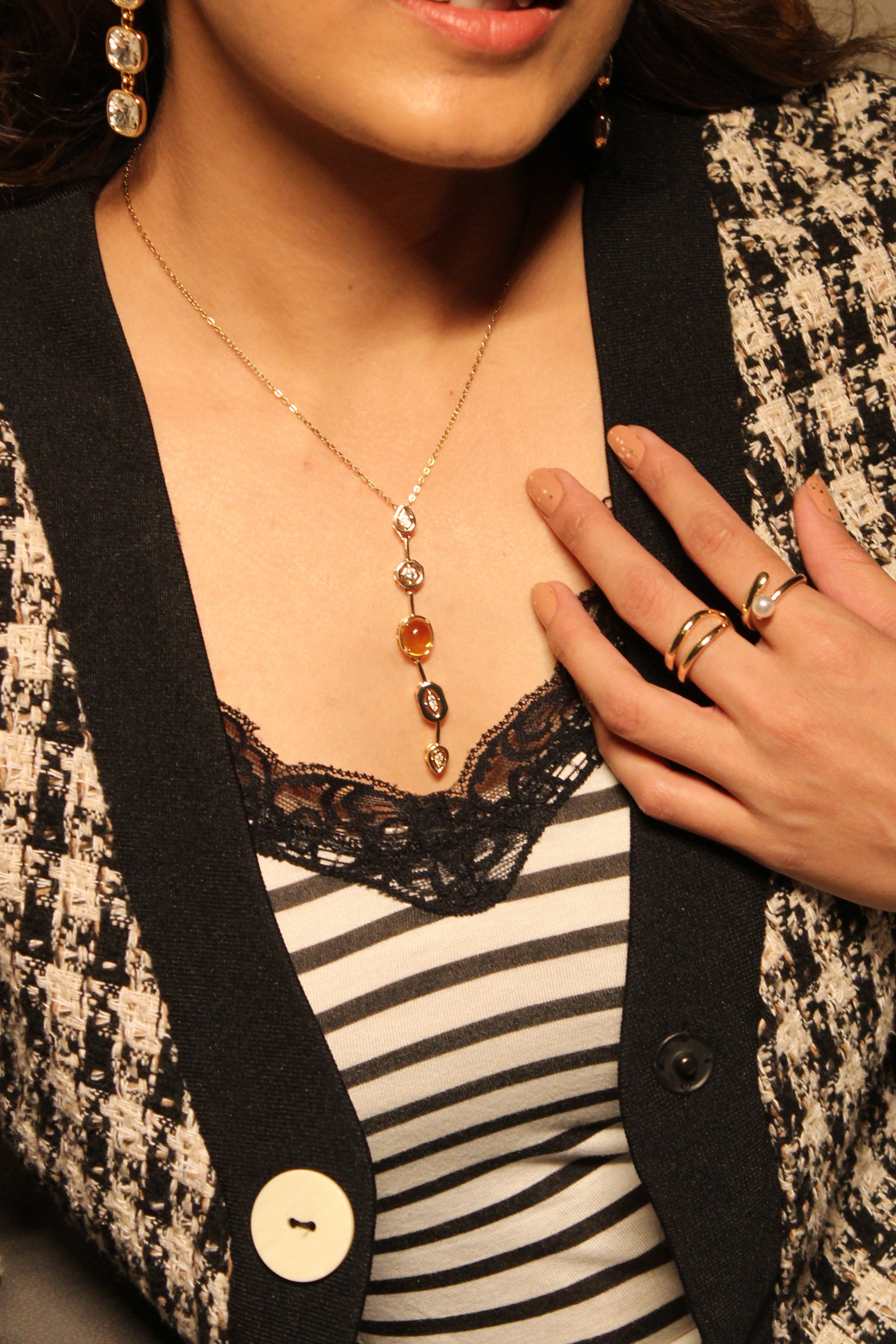 model wearing a Coralie Necklace with a blurred background