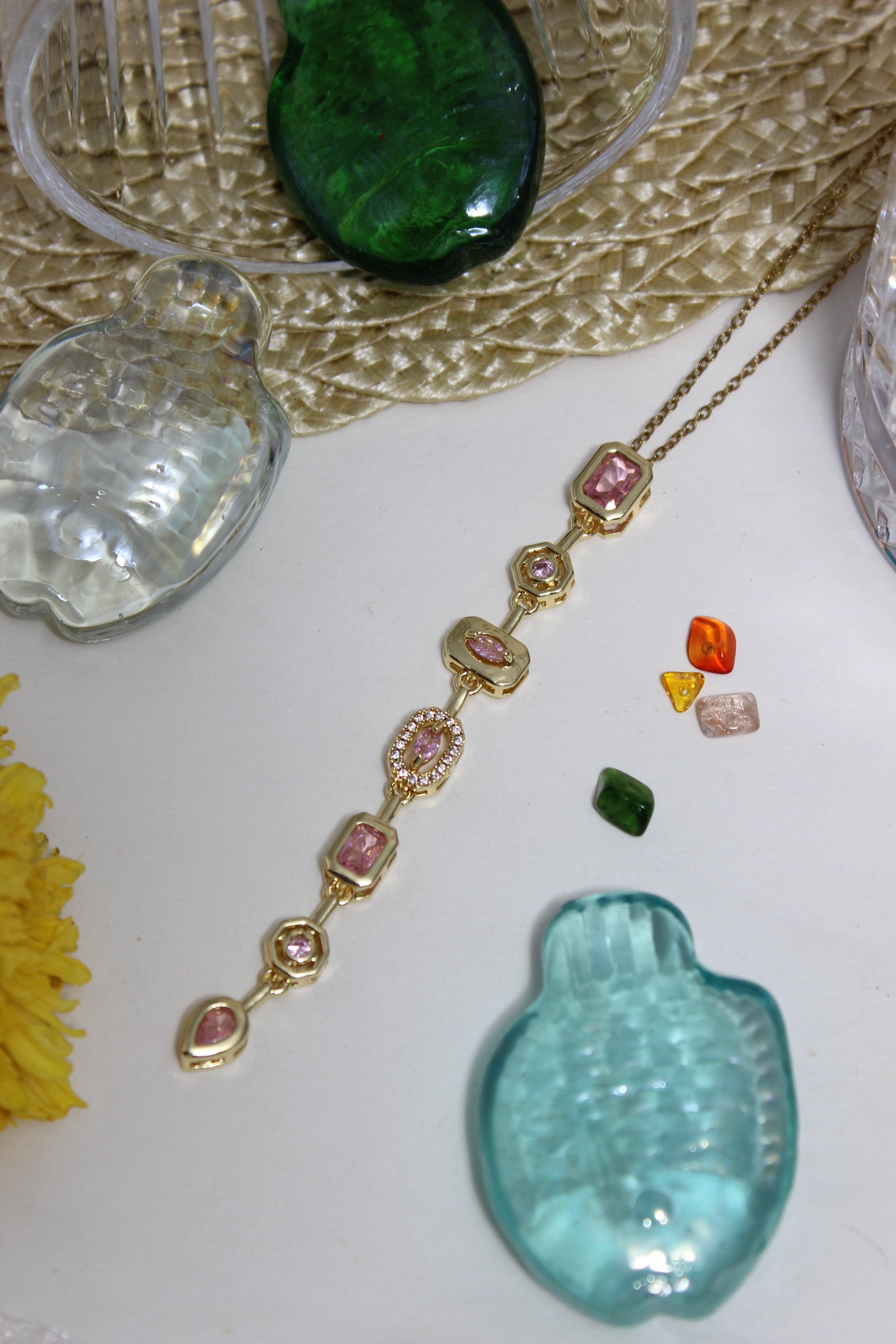 Blush Pastel Pour Necklace on a textured surface