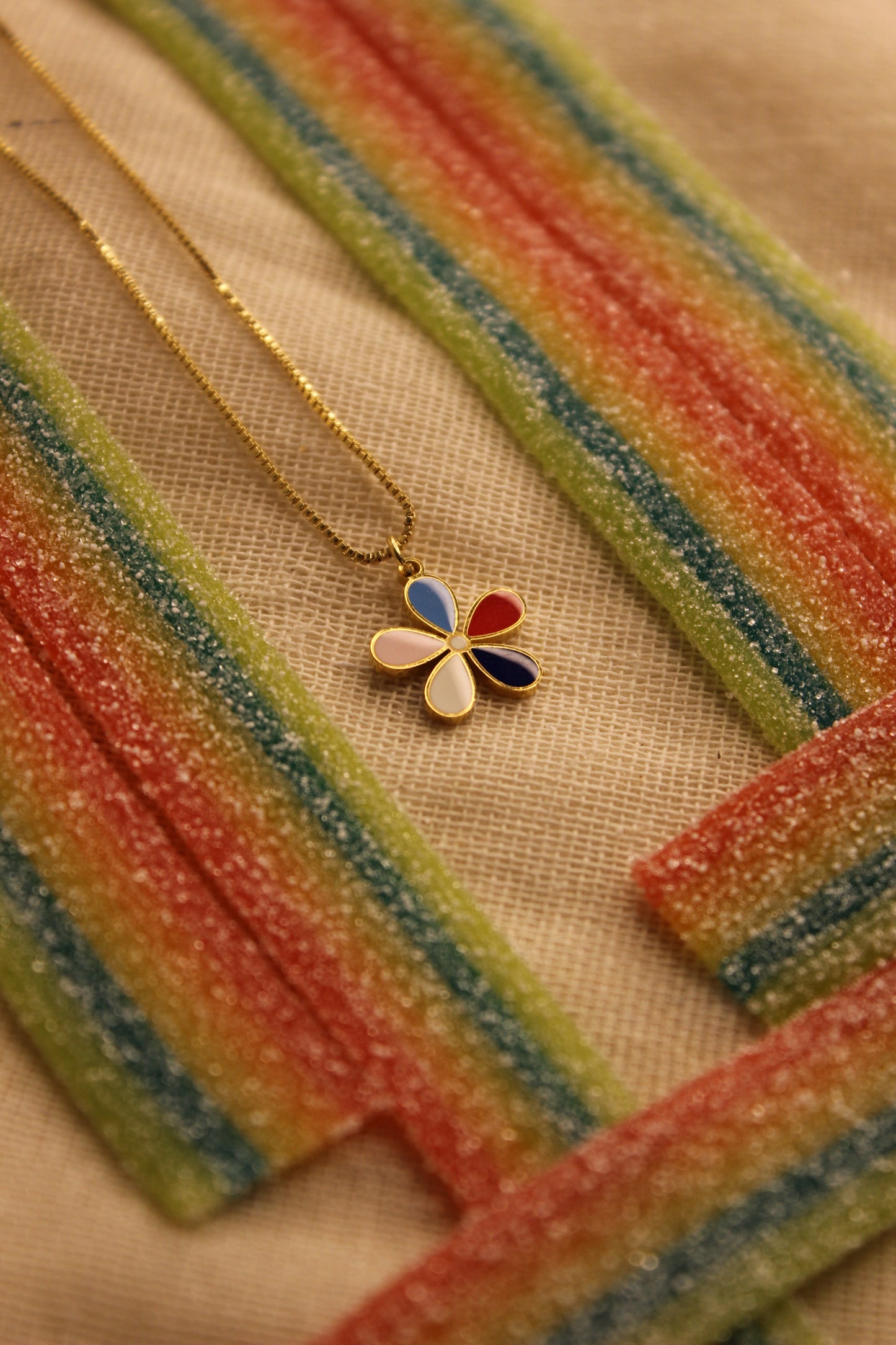 Colorbud Pendant Necklace on a textured surface