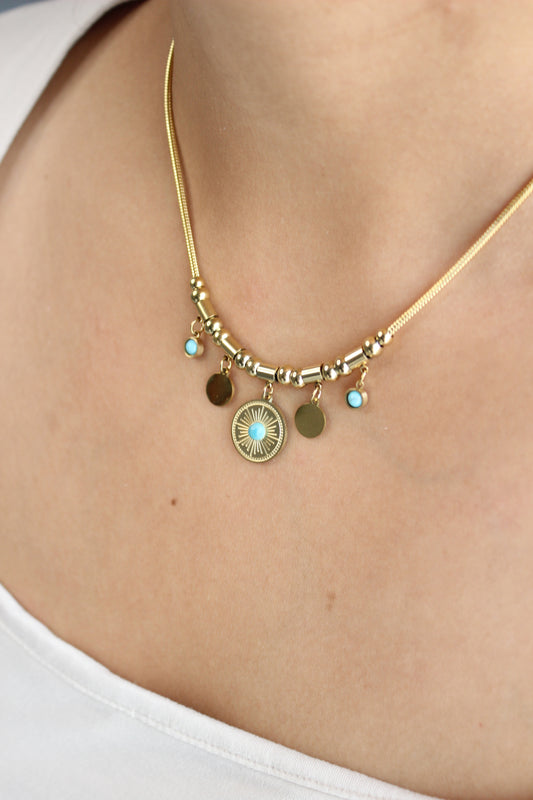 Solstice Medallion Necklace on a model wearing a white top