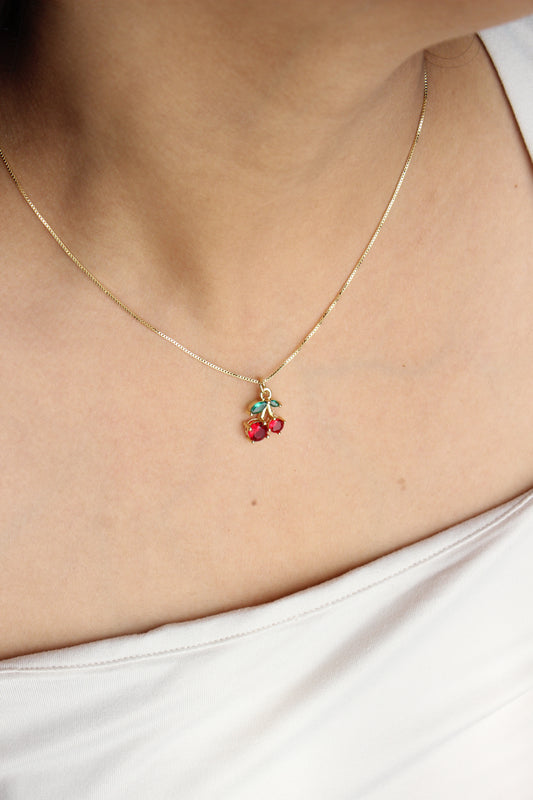 Cherry Glint Pendant Necklace on a person wearing a white top