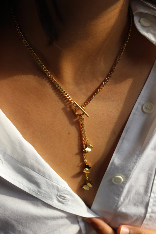 Butterfly Drizzle Necklace on a model wearing a white shirt