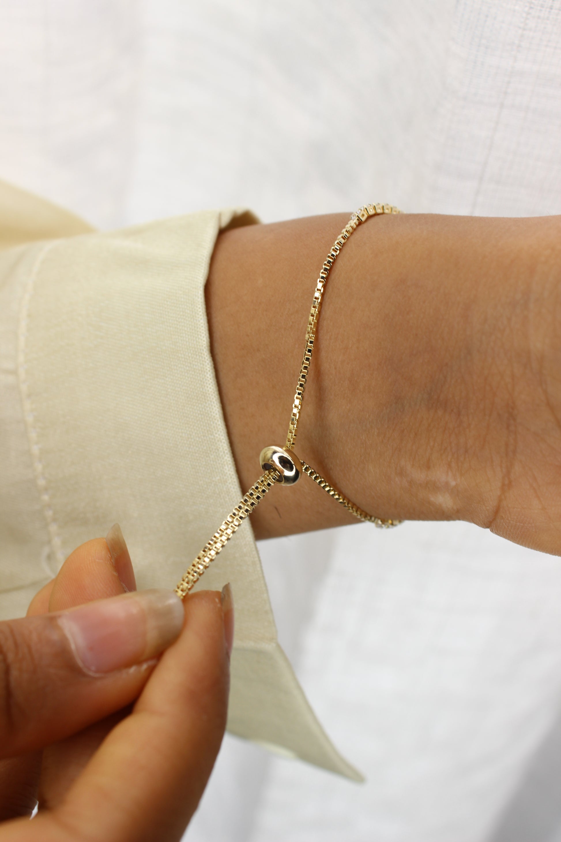 Maristar String Bracelet on a model's wrist with a plain background