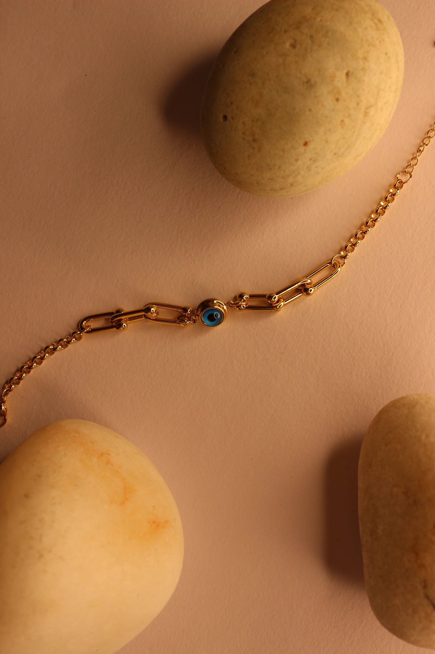 Pelora Bracelet on a beige surface with stones