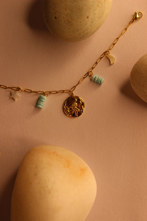 Deep Relic Charms Bracelet on a pink surface with bath bombs