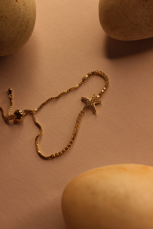 Maristar String Bracelet on a beige surface