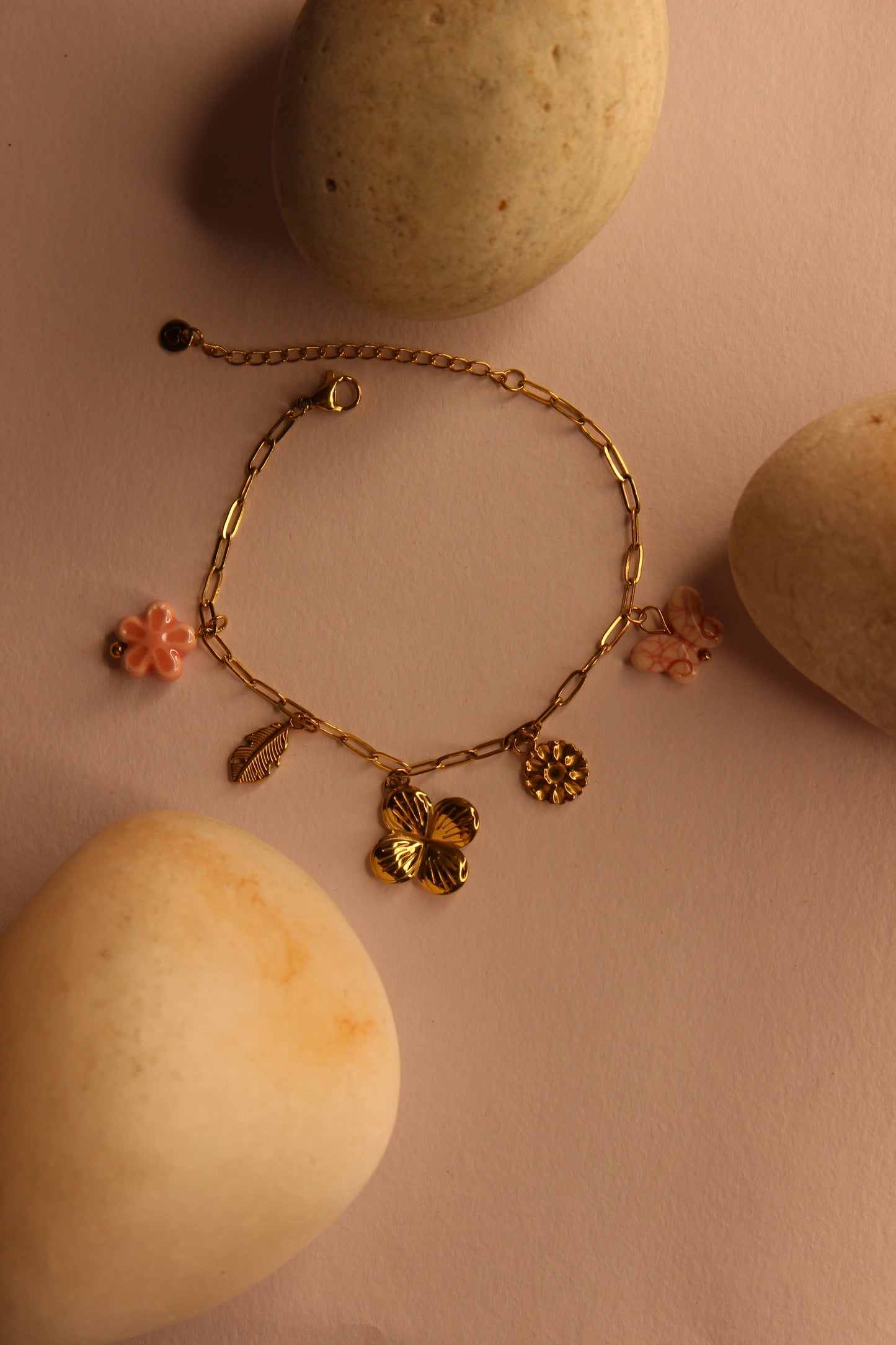 Flutter Bloom Charms Bracelet on a yellow surface with stones
