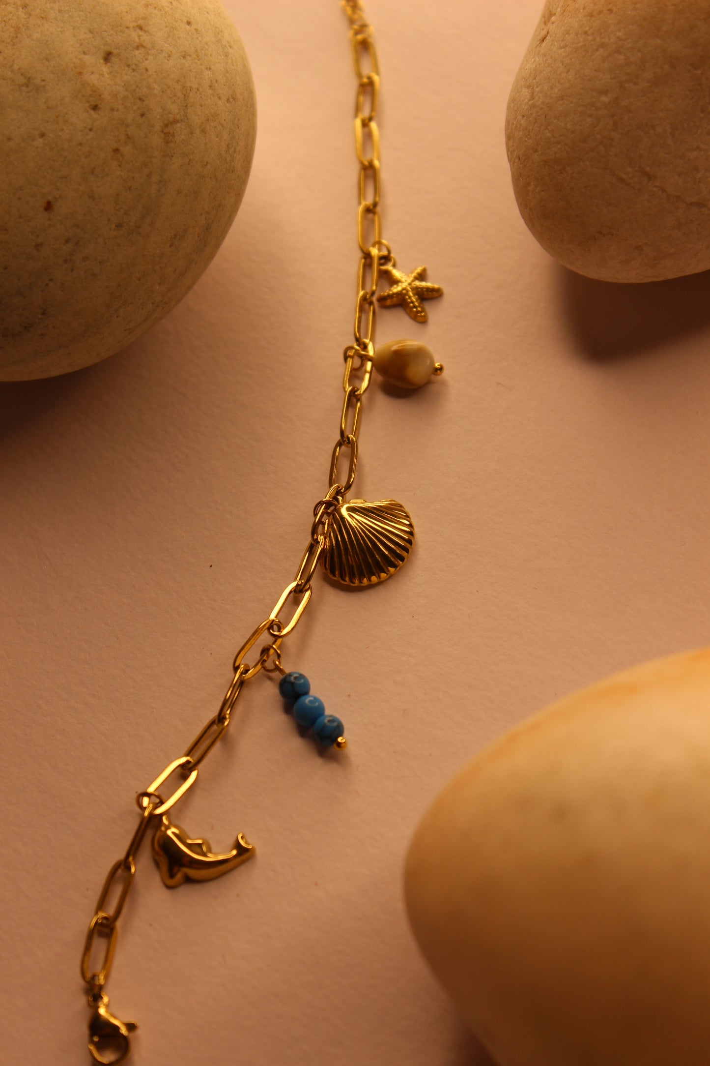 Drifted Charms Bracelet on a beige surface
