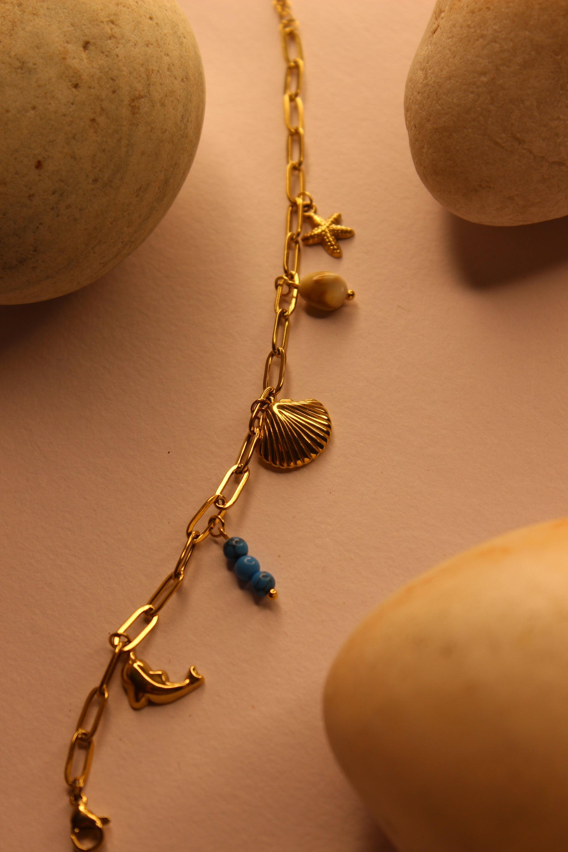 Drifted Charms Bracelet on a beige surface