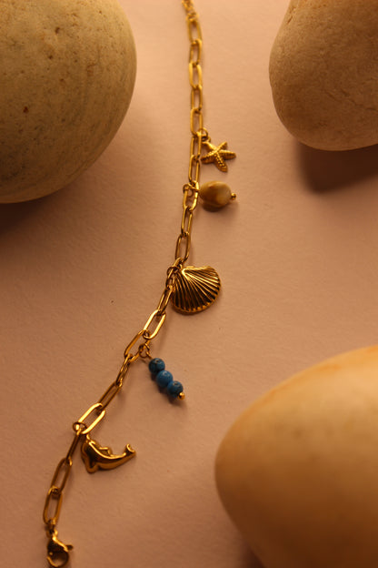 Drifted Charms Bracelet on a beige surface