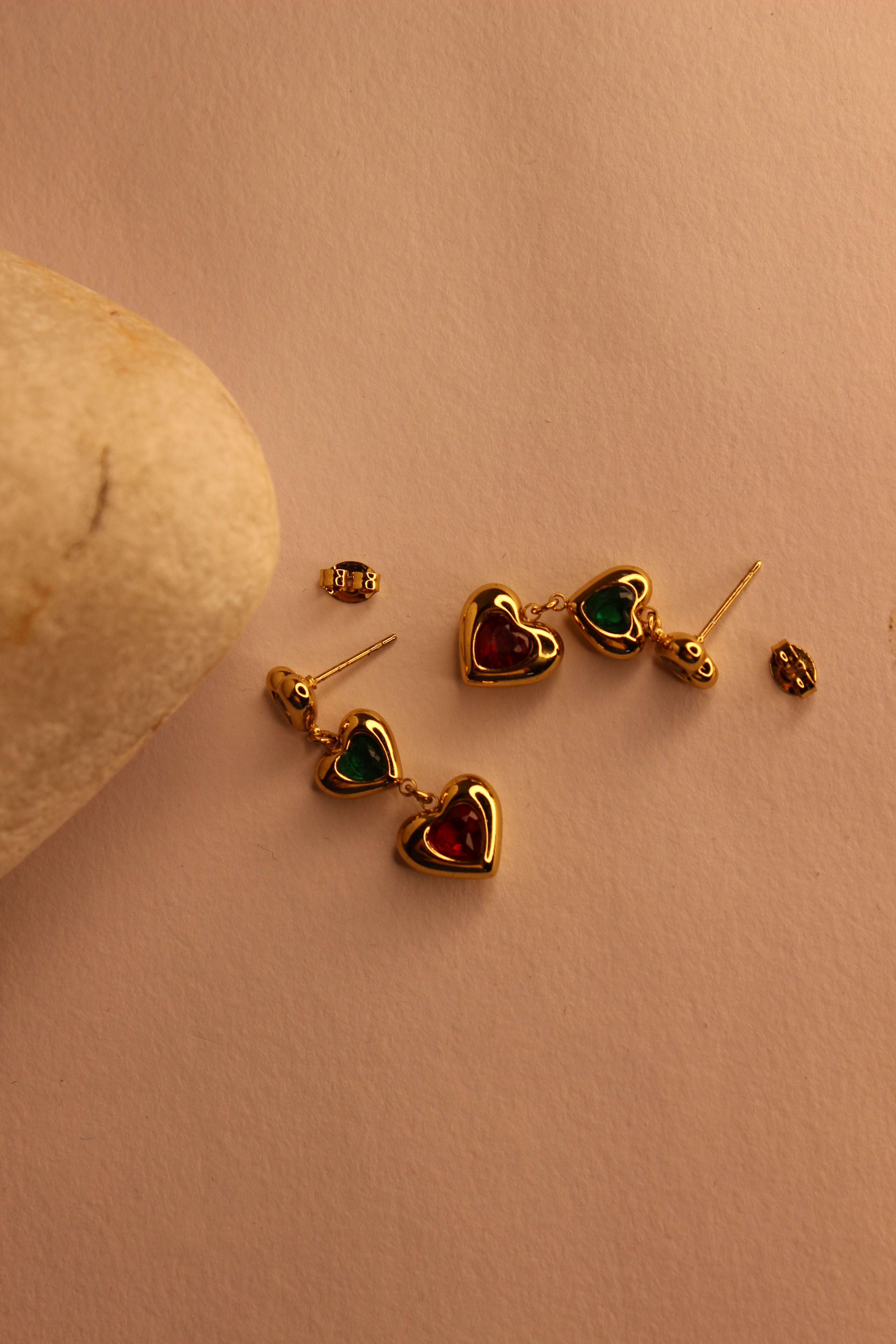 Hearts in Hue Earrings on a beige surface