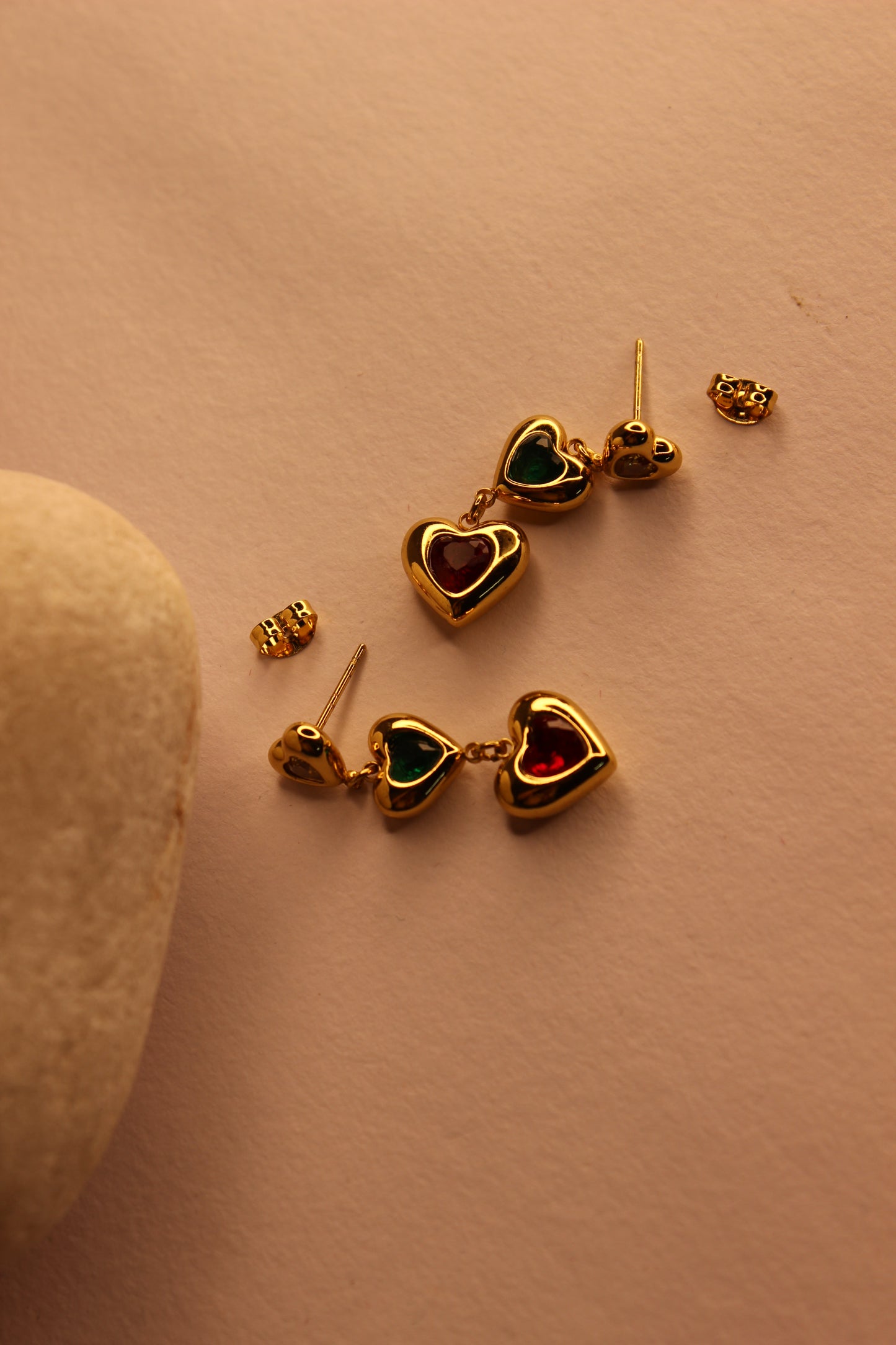 Hearts in Hue Earrings on a light brown surface