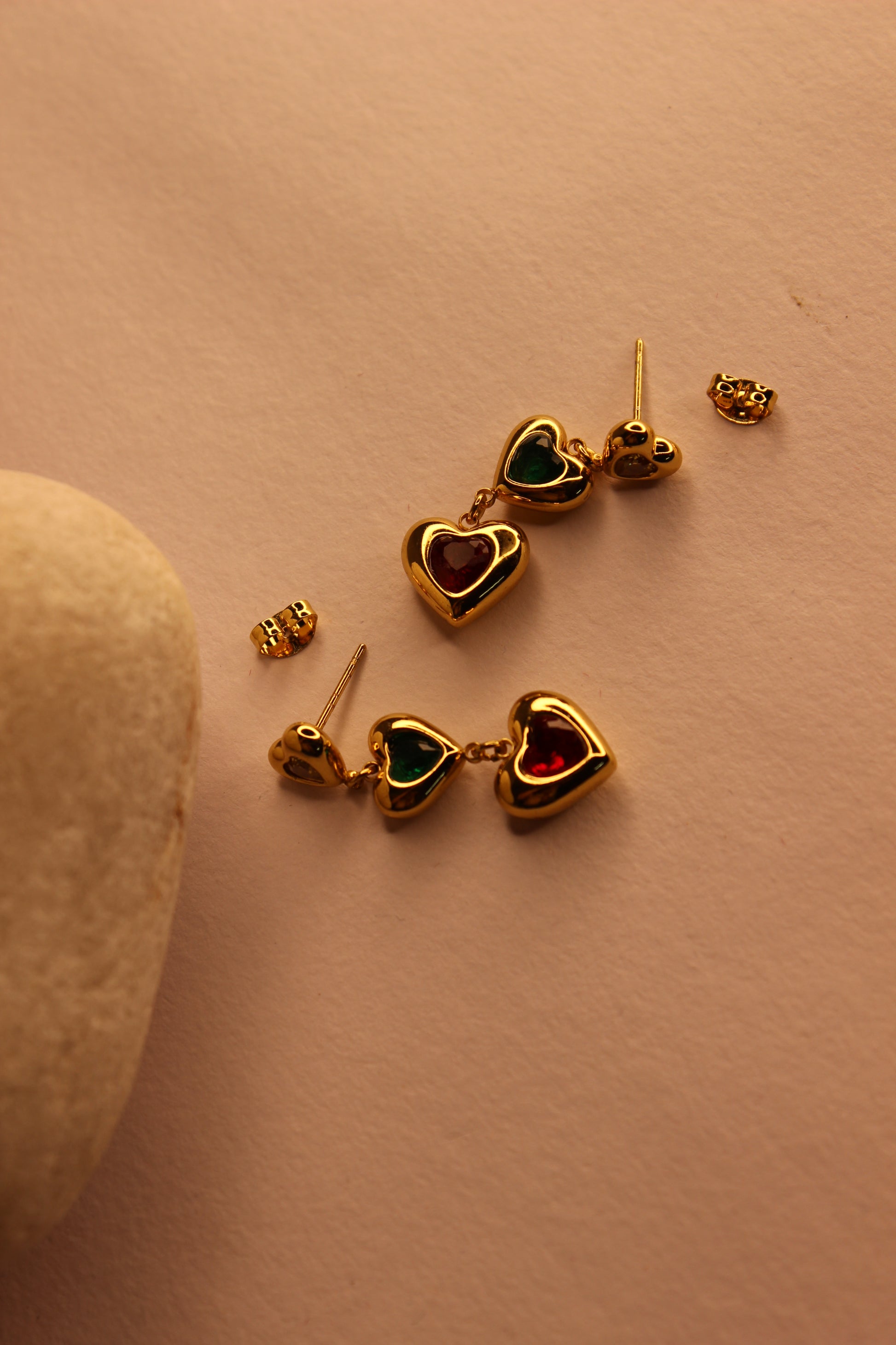 Hearts in Hue Earrings on a light brown surface