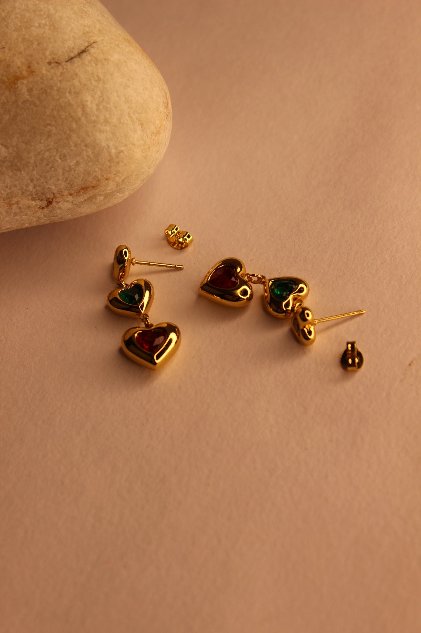 Hearts in Hue Earrings with gemstones on a beige surface