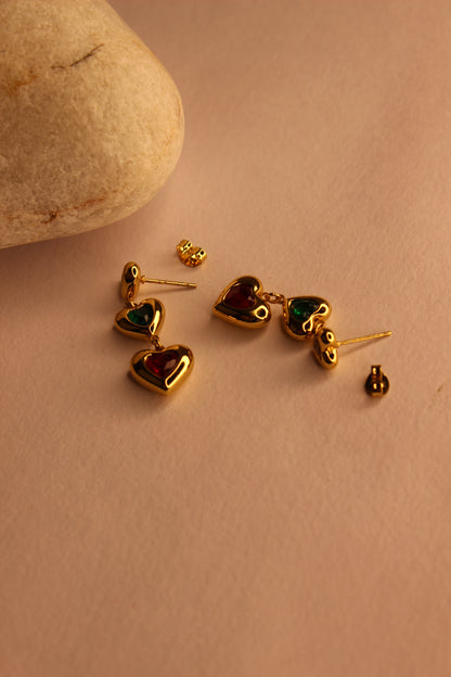Hearts in Hue Earrings with gemstones on a beige surface