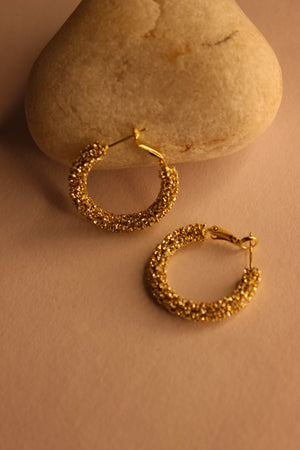 Lumira Hoop Earrings on a stone surface