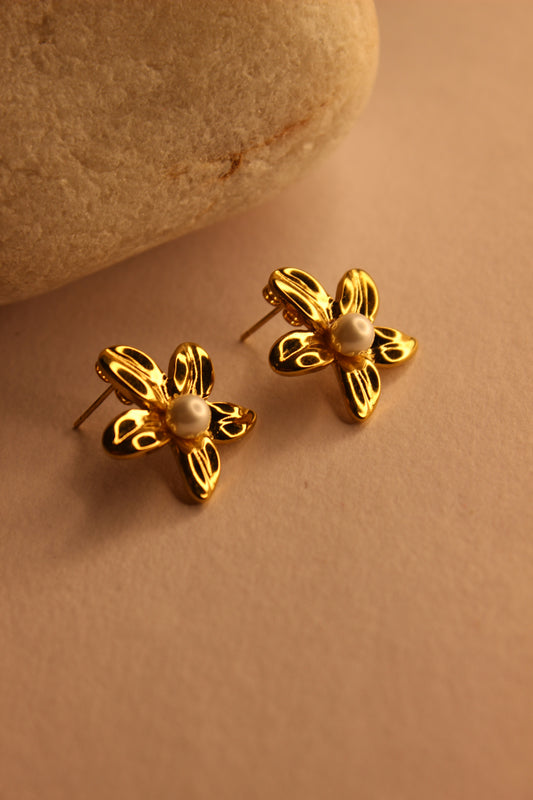 Golden Whisper Stud Earrings on a beige background