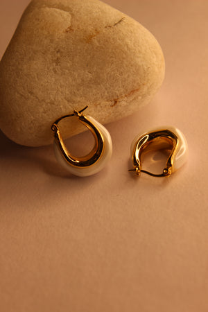Mira Pearl Hoop Earrings on a beige stone surface