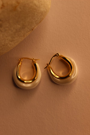 Mira Pearl Hoop Earrings on a light brown background