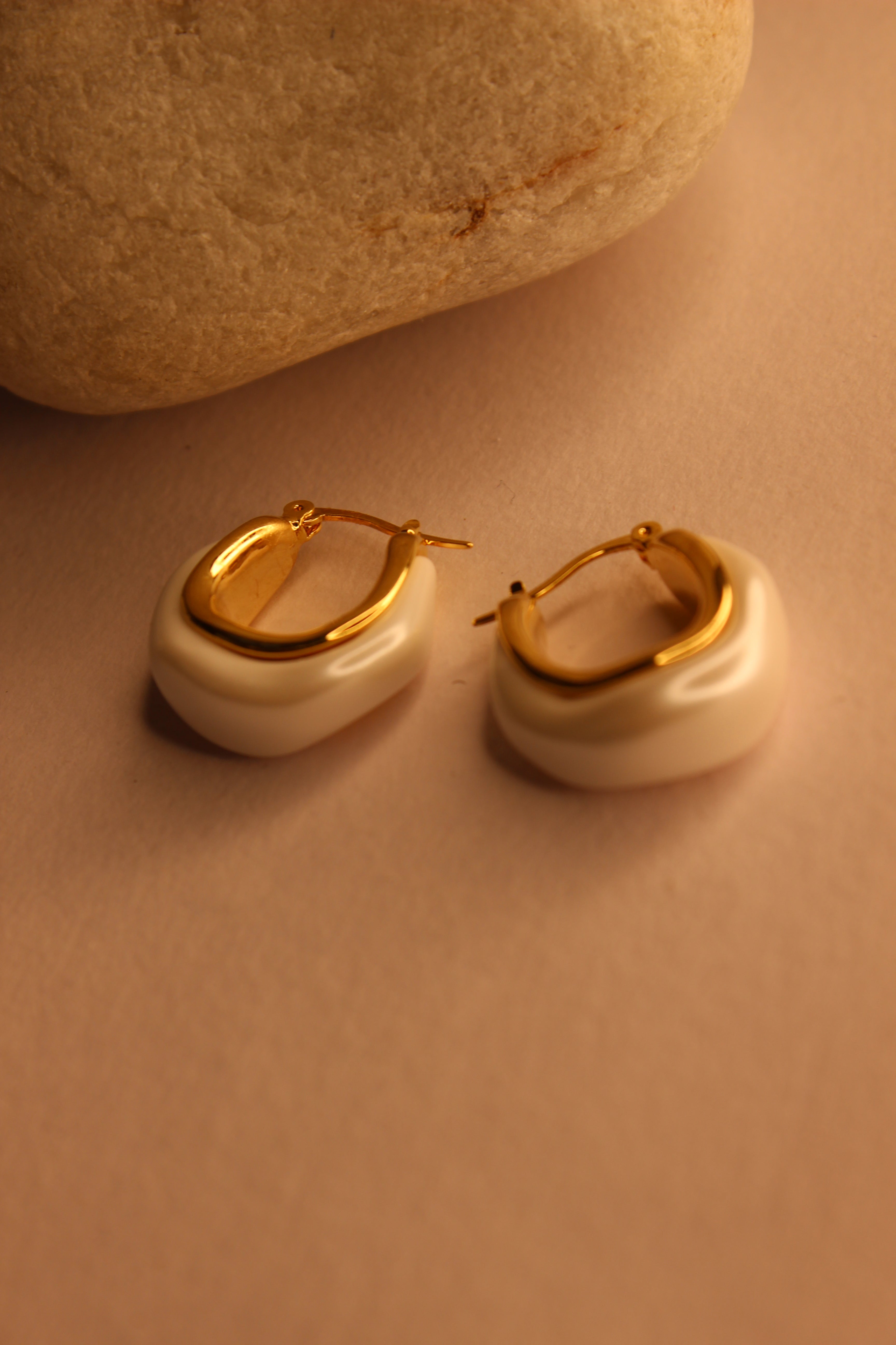 Mira Pearl Hoop Earrings on a beige background