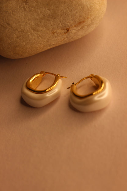 Mira Pearl Hoop Earrings on a beige background