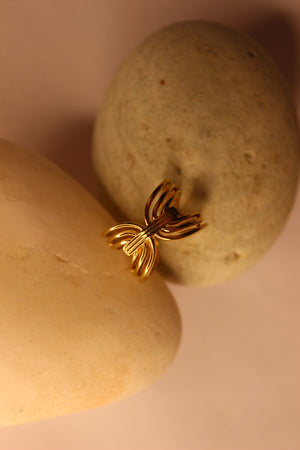 Lume Ring with a unique design on a stone surface