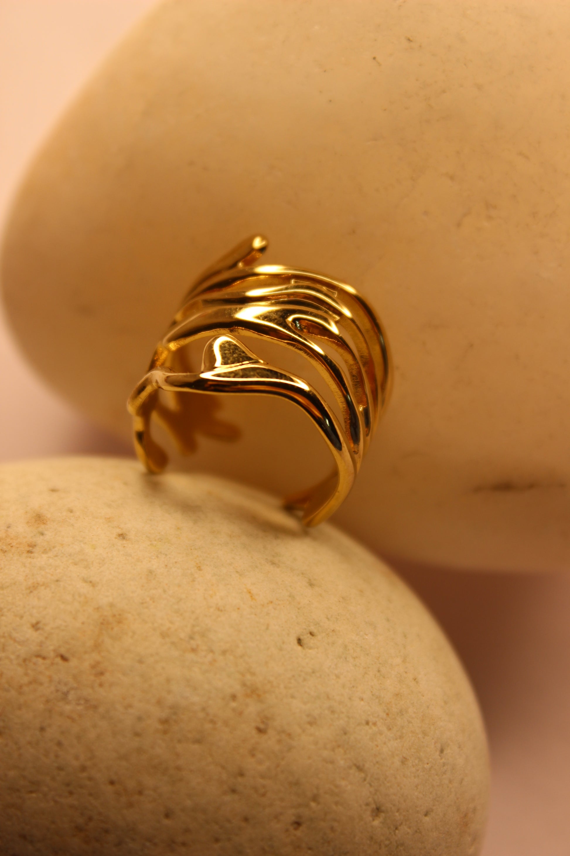 Auriel Ring with a wavy design on a beige background