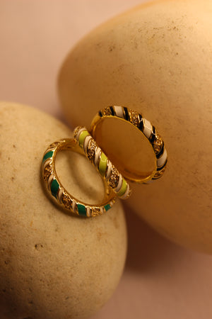 SolPop Ring with green and black accents on a beige stone surface