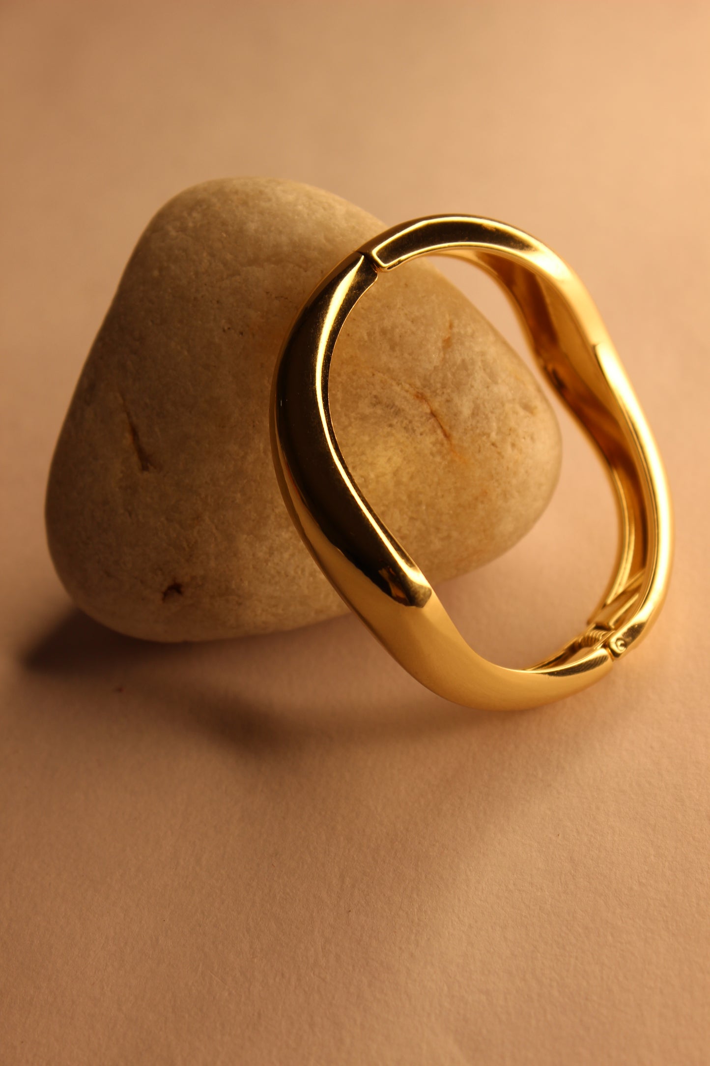 Velda Bracelet on a stone surface with a beige background