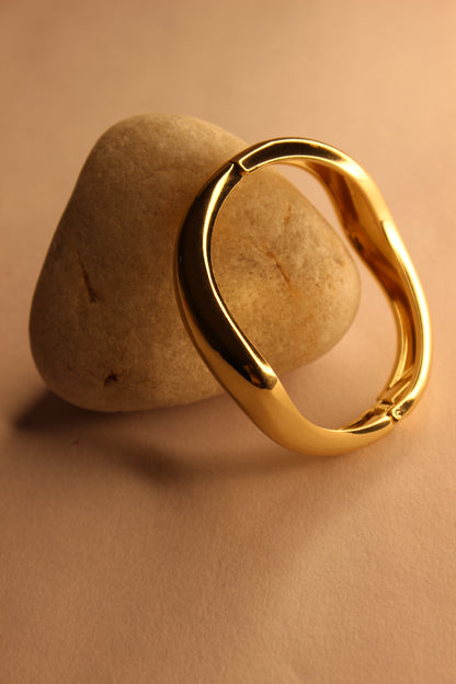 Velda Bracelet on a stone surface with a beige background