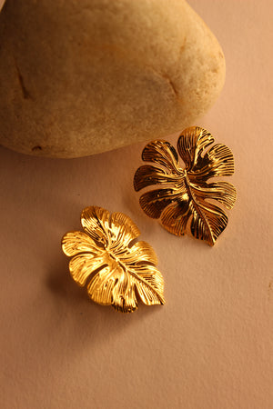 Leafora Earrings on a light brown surface
