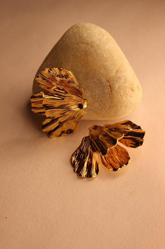 Ethereal Fleur Earrings on a beige stone surface