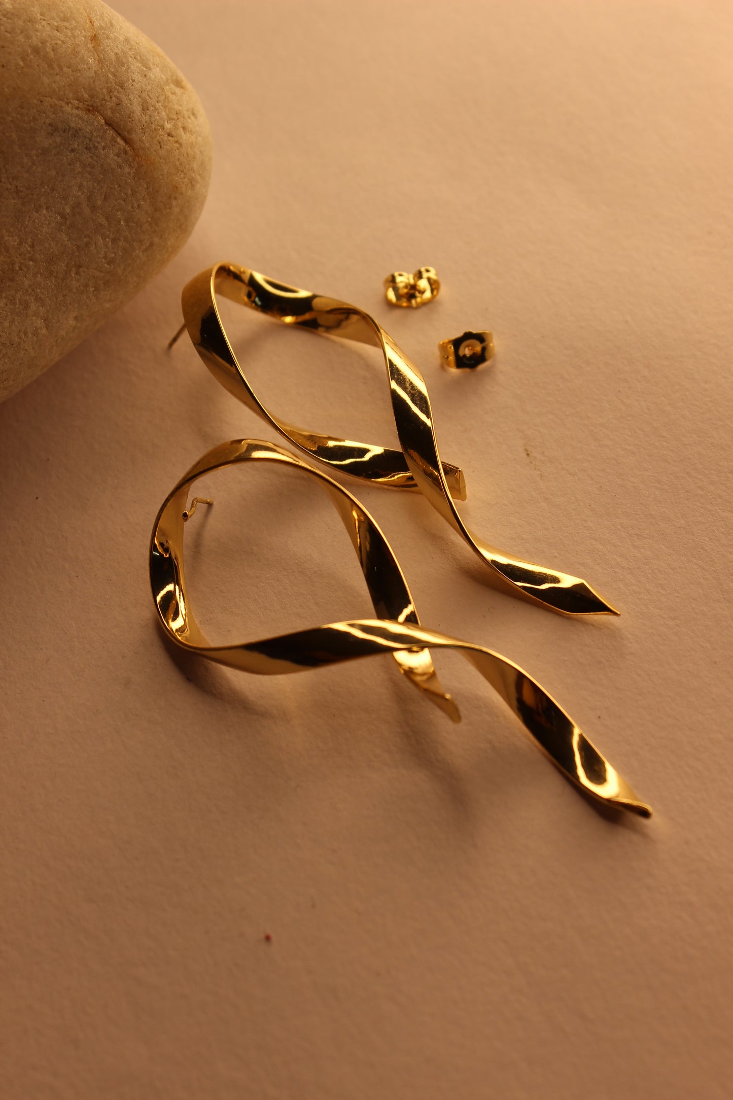 Selene Wave Earrings on a beige surface