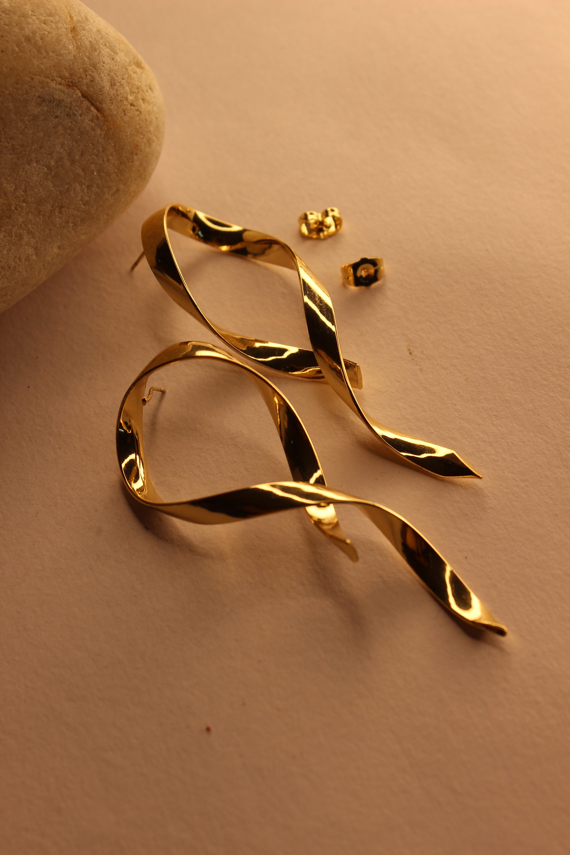Selene Wave Earrings on a beige surface