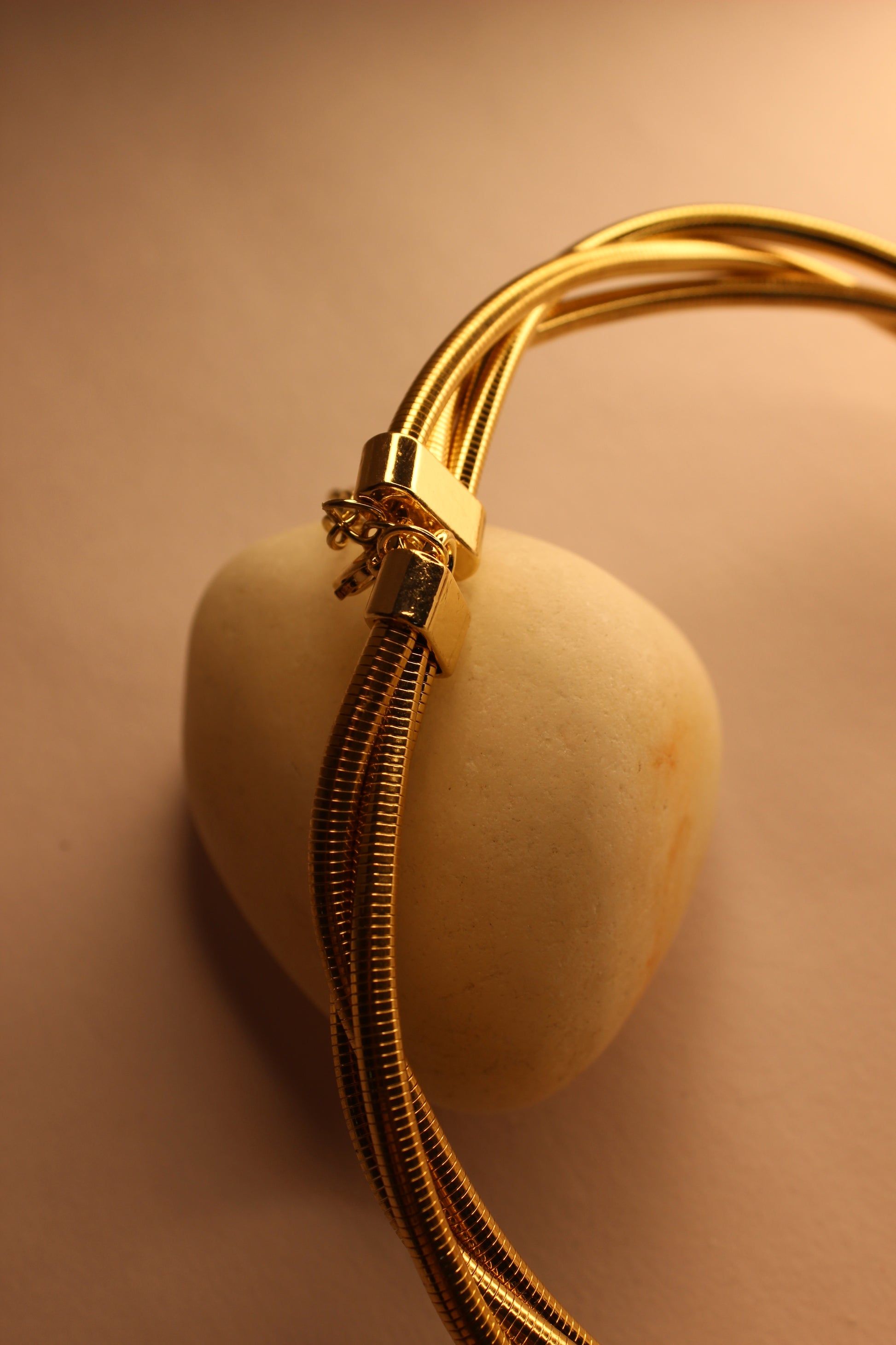 Torra Necklace on stone in yellow background