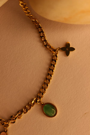 Elegant WishBlush Charms Necklace displayed on stones, perfect for personalized fashion accessories