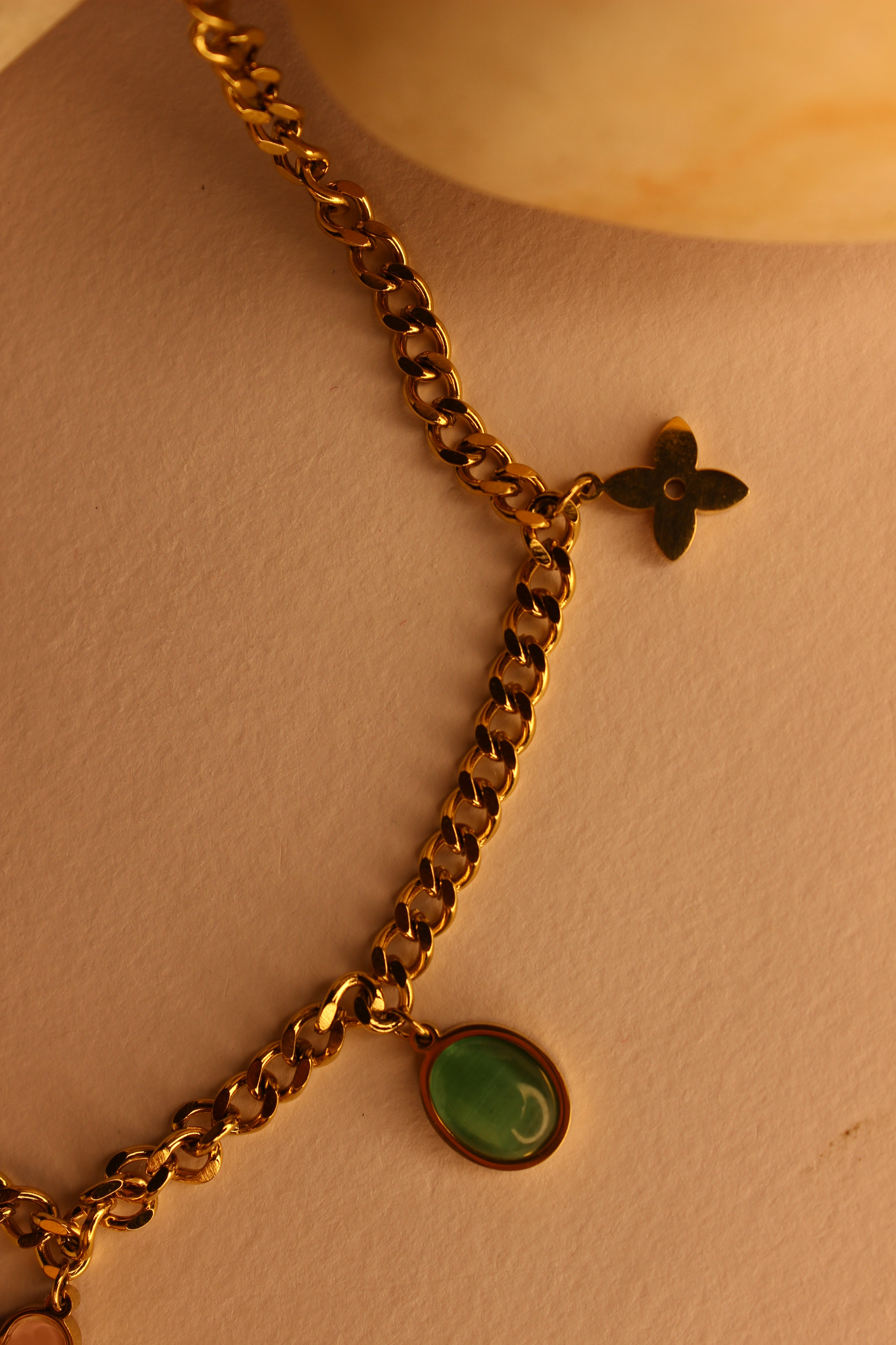 Elegant WishBlush Charms Necklace displayed on stones, perfect for personalized fashion accessories