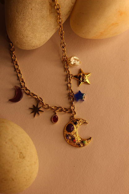 Lunar Spells Charms Necklace on a beige stone background
