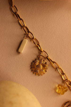 Hearts in Bloom Charms Necklace on a light brown background