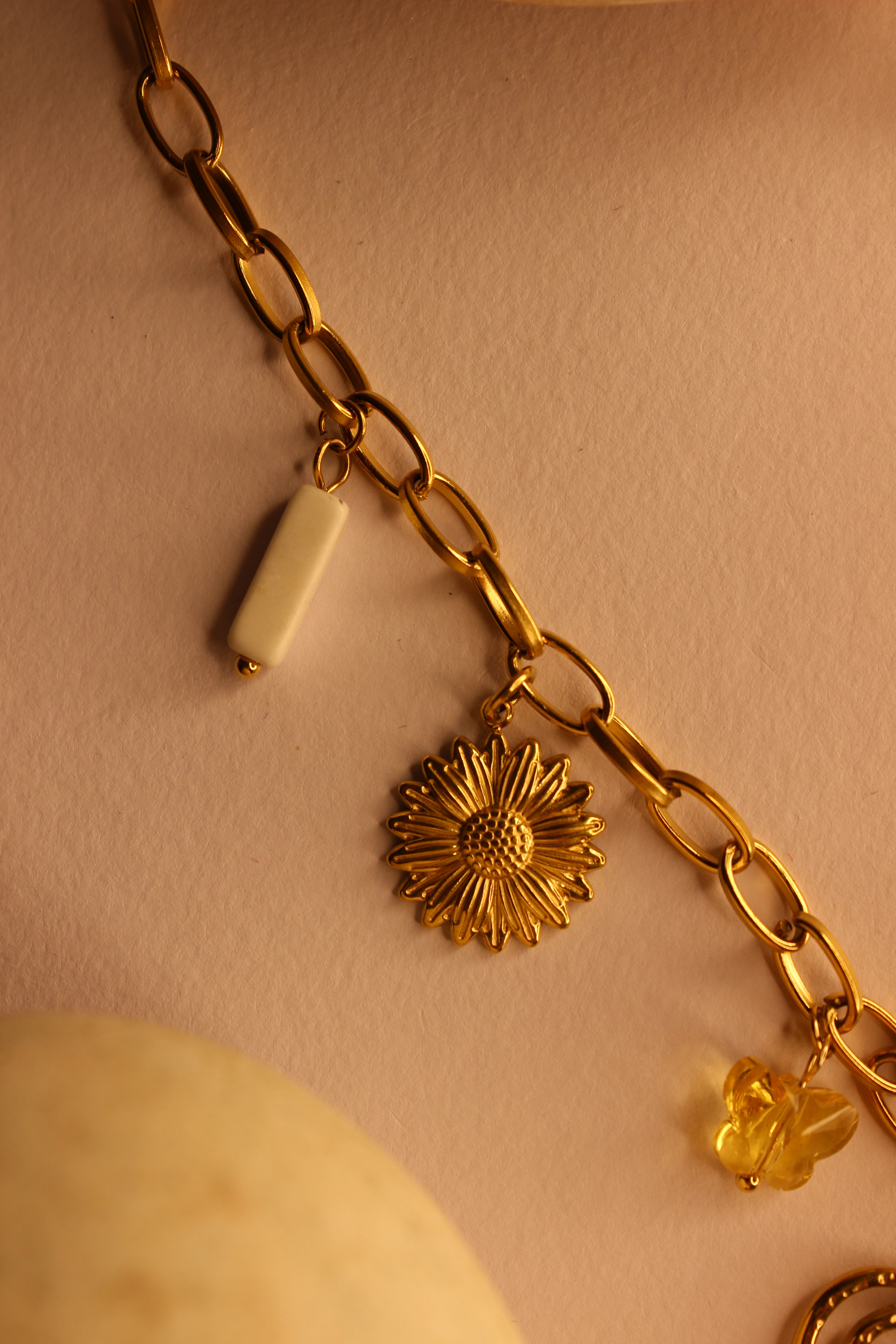 Hearts in Bloom Charms Necklace on a light brown background