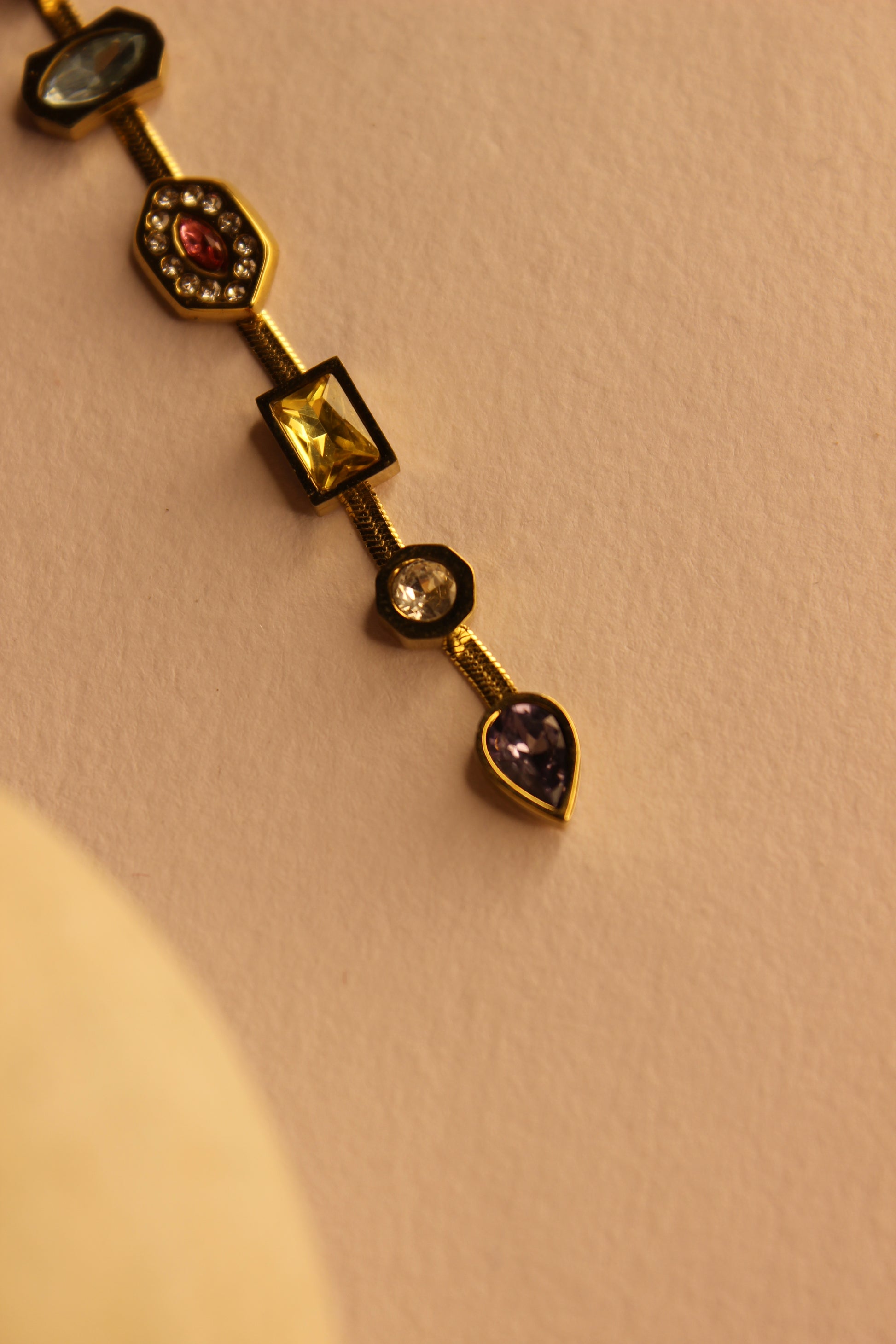 Gemline Necklace with gemstones on a beige background