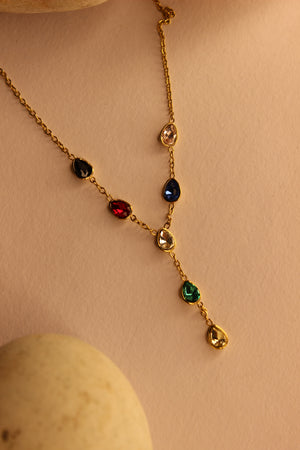 Prism Drop Necklace on a beige background