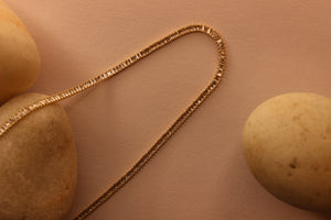 Twilite Necklace on yellow background