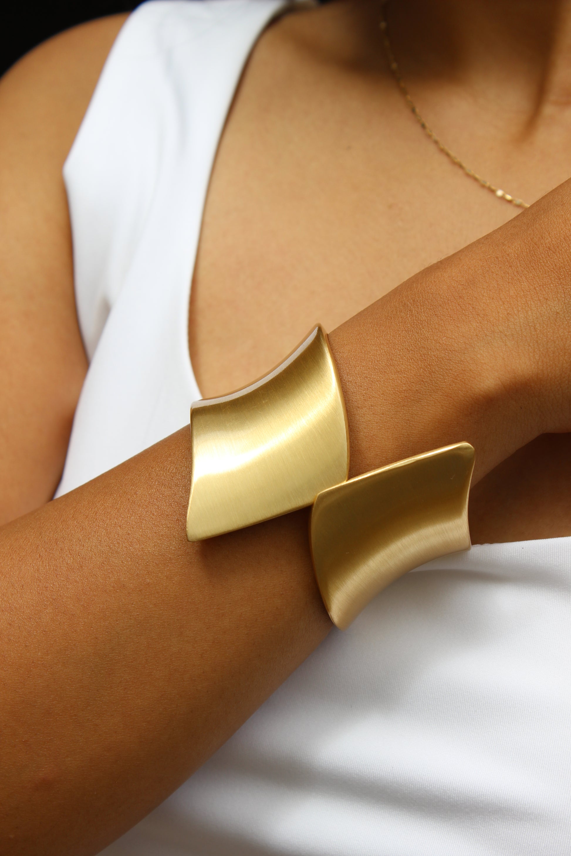 Arcus Bracelet on a model wearing a white top against a neutral background