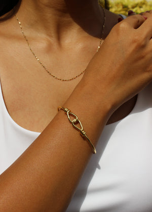 Close-up of a model wearing a Tether Cuff Bracelet against a white background