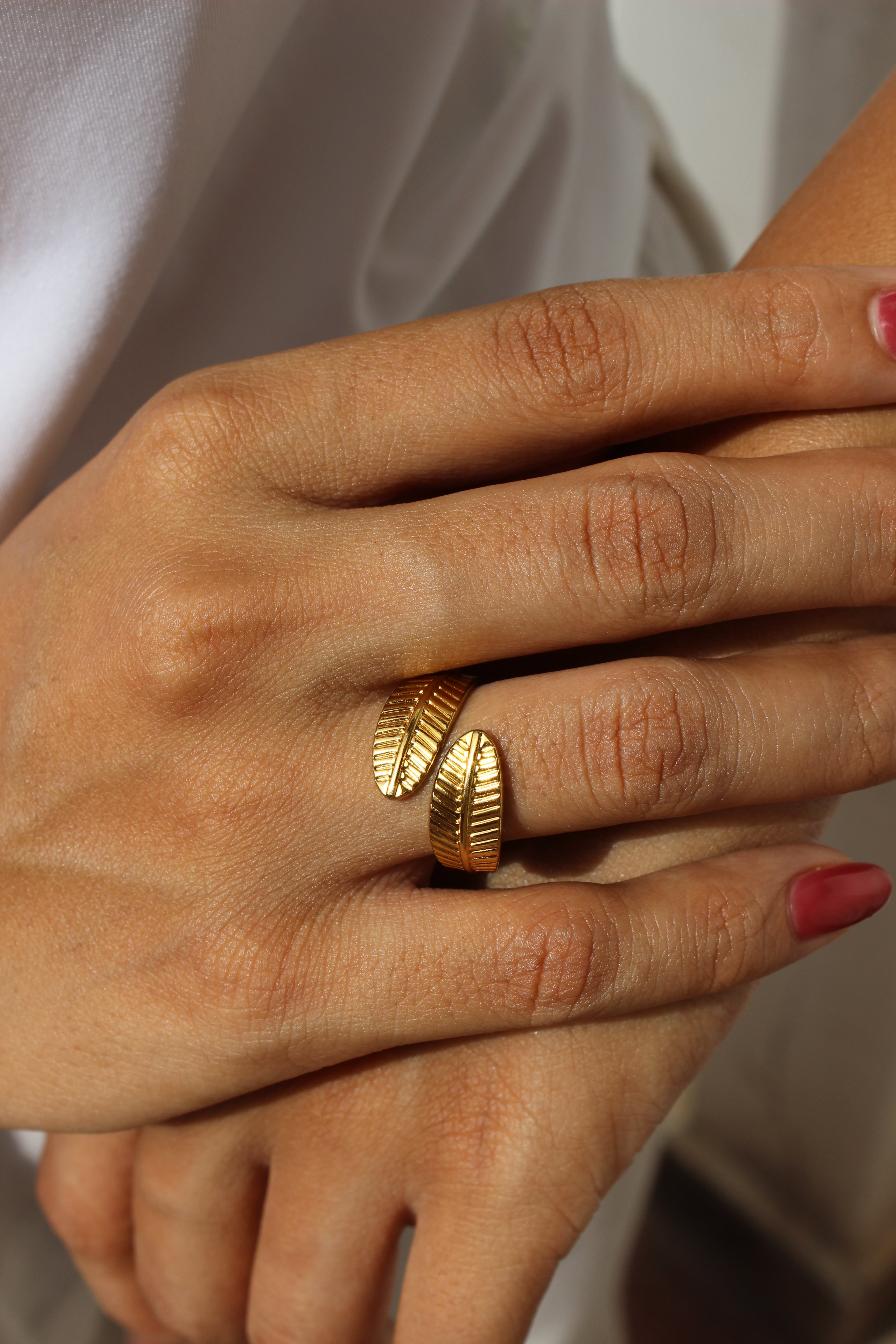 Hand wearing Adara Ring with a soft background
