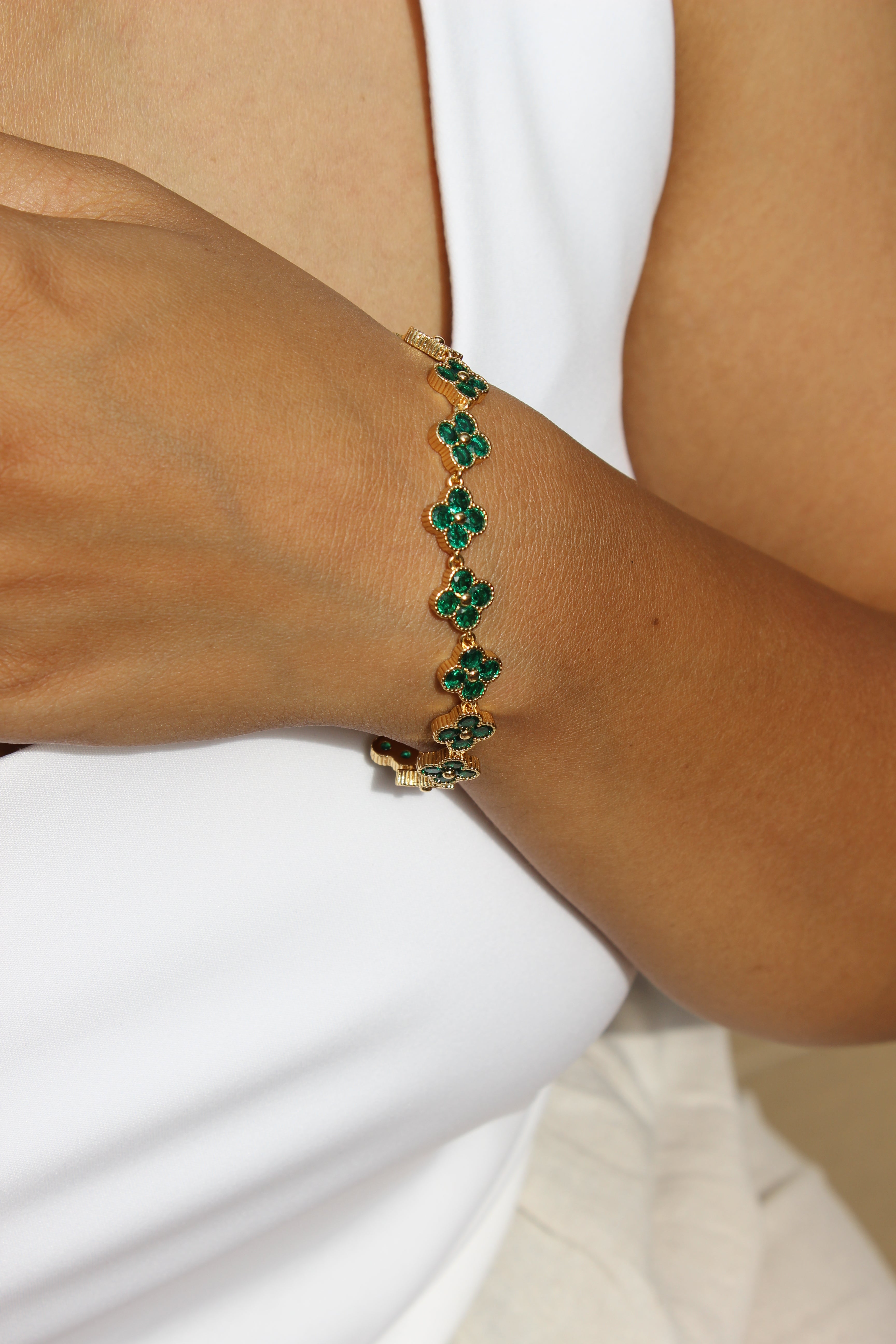 Sage Bloom Bracelet with green gemstones on a wrist against a white background